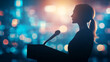 © sceneperfect - Silhouette of a confident speaker at a podium, against a backdrop of vibrant lights, capturing the essence of public speaking.