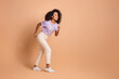© deagreez - Full length profile portrait of pretty young woman run empty space wear t-shirt isolated on beige color background