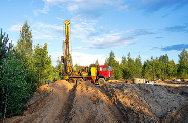 Deep foundation machine. Drilling rig, Pile driver at construction site. Pile driven in ground by vibrating hydraulic hammer. Foundation construction. Drilling rig crude oil.