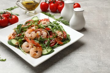 Delicious shrimp salad with ingredients on grey textured table