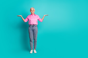 Poster - Full size photo of pretty aged woman hold empty space wear shirt isolated on teal color background