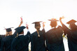 © Hira/peopleimages.com - Graduation, diploma or back of students with certificate at university for education, opportunity or success. College, scholarship or group of people at campus with degree, hands up or achievement
