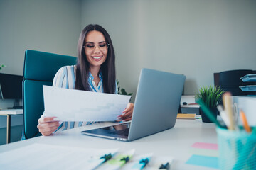 Wall Mural - Photo of smart chief female working document graph wear striped formalwear comfortable modern office interior indoors workspace