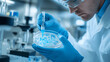© Matthias - Scientist inspecting petri dish with bacteria samples in sterile lab