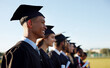 © peopleimages.com - Happy people, students and graduation with class in line at ceremony for academic achievement or diploma. Young, group or graduates with smile in row together for degree, certificate or qualification
