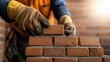 © Samvel - Industrial bricklayer installing bricks on construction site