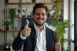 © eartist85 - Confident smiling businessman showing thumb up gesture.