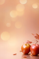 Ripe apples with leaves on orange bokeh background, concept of freshness