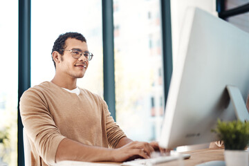 Wall Mural - Business man, computer and typing for research, administration and company report with glasses. Graphic designer, technology and design in office for digital agency, project and website with smile