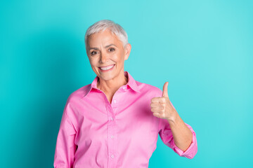 Canvas Print - Portrait of pretty aged lady show thumb up wear pink shirt isolated on turquoise color background