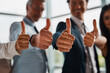 © StarDweller/peopleimages.com - Business people, hands and team with thumbs up for winning, good job or corporate success at office. Closeup, group or employees or colleagues with like emoji or yes sign for company feedback or vote