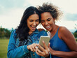 © StarDweller/peopleimages.com - Friends, laughing and phone in park for relax, social media and funny joke with grass and sunshine. People, happy and mobile outdoor for internet meme, news article and streaming with gossip and chat