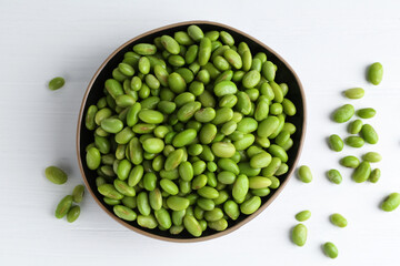 Wall Mural - Fresh edamame soybeans in bowl on white wooden table, top view