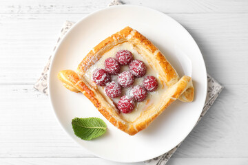 Poster - Tasty puff pastry with raspberries on white wooden table, top view