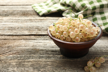 Wall Mural - Fresh white currant berries in bowl on wooden table, closeup. Space for text