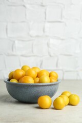 Sticker - Ripe plums in bowl on light textured table