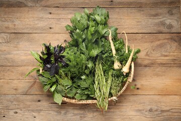 Wall Mural - Different aromatic herbs in wicker basket, top view