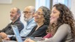 © Nany - Adults in a classroom, each working on a laptop during a computer-based learning session