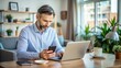 © Man888 - Busy professional multitasking on laptop computer while texting on smartphone, sitting at desk with coffee cup and notebook in modern home office setting.