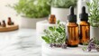 © Aliaksandra - bottles of essential oils and natural remedies displayed on white marble surface for alternative medicine concept banner with copy space