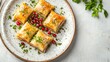 © Focusshop - A plate of baklava, a traditional Middle Eastern pastry, topped with pomegranate seeds and pistachios.