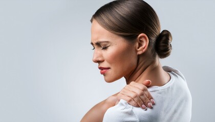 Close-up portrait of woman in white enduring sharp back pain.