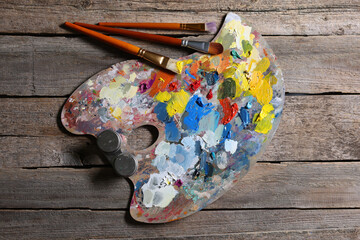 Sticker - Artist's palette, brushes and paints on wooden table, flat lay