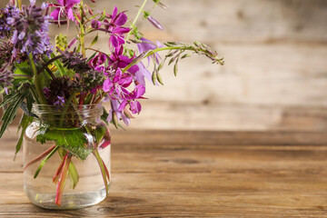 Sticker - Bouquet of different healing herbs on wooden table. Space for text