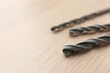 © New Africa - Different drill bits on wooden surface, closeup. Space for text