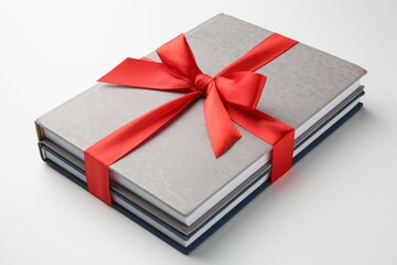 Wall Mural - Books tied with red ribbon on white background, closeup