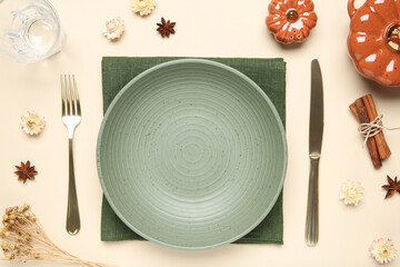 Poster - Beautiful table setting with autumn decor on beige background, flat lay