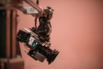 A professional film and video camera on the set. Filming day, equipment and crew. Technique of modern video filming.