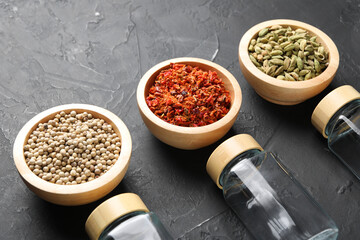 Poster - Different spices and glass jars on black table