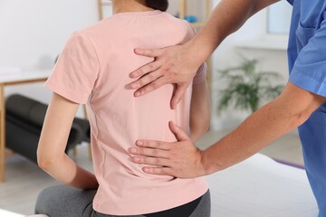 Canvas Print - Physiotherapist working with patient in rehabilitation center, closeup