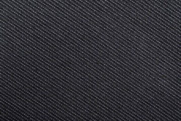 Texture of dense black fabric for tailoring. Canvas. Textile
