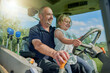 © Sanc/peopleimages.com - Happy father, daughter or ride with tractor on farm for conversation, agriculture or natural production. Dad, child or little girl with smile for industrial vehicle, growth or maintenance on farmland