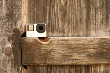 Canvas Print - One modern action camera on wooden surface