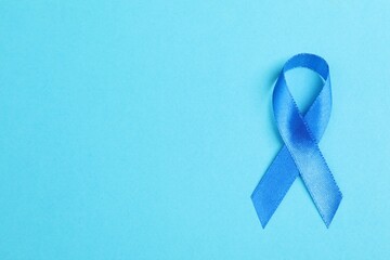 Wall Mural - Blue ribbon on color background, top view with space for text. Prostate cancer awareness