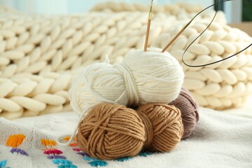 Wall Mural - Skeins of yarn and knitting needles on soft blanket