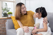 © charnsitr - Asian mother having a good time chatting with her daughter at home