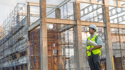 Two Asian engineer working at site of a large building project,Work overtime at construction site,Team of engineer discus at site,The architect, supervisor, and foreman meet to discuss the design