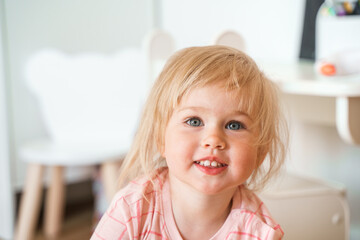 Portrait of a two-year-old toddler child Caucasian girl at home.