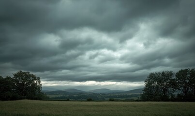 dark, overcast sky looming above a quiet countryside