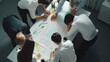 © InfiniteFlow - Top view of professional business team working together to brainstorm environmental idea by using mind map. Aerial view of smart manager talking and discussing about sustainable energy. Alimentation.