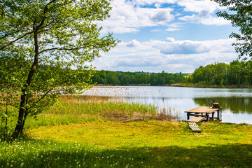 Wooden pier at beautiful lake during sunny summer day, Suwalski Landscape Park, Podlasie, Poland