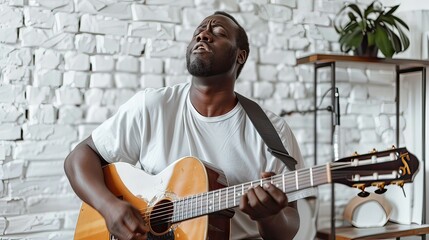 Focused Black male artist in a modern studio, deeply involved in singing and playing his acoustic guitar. 