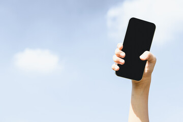 Sticker - Recyclable smartphone held in hand up on sky background. Hand holding electronic waste for recycle reduce and reuse concept to promote clean environment with recycling management. Gyre