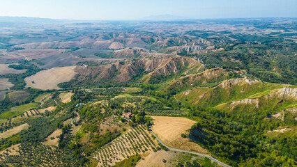 An aerial view of Le Balze di Volterra and the San Giusto Volterra in Tuscany, Italy, captured by a drone. Le Balze di Volterra is a dramatic and unique landscape of steep cliffs