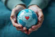 © Saqib - A pair of hands gently holding a globe with a heart symbol in the center, all illustrated in soft blue and white tones. 5th September International Day of Charity.