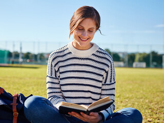 Leinwandbilder - Reading, smile and woman in nature, outdoor and studying of literature, student and education in book. Knowledge, campus and learning in college, person and girl in school, scholarship and grass
